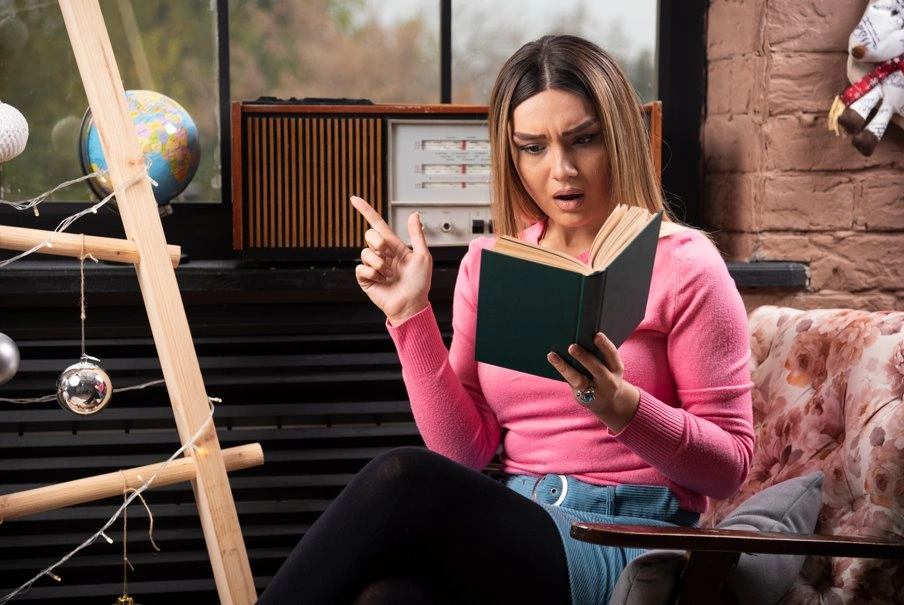 Woman reading a book while planning a book publicity and marketing strategy.