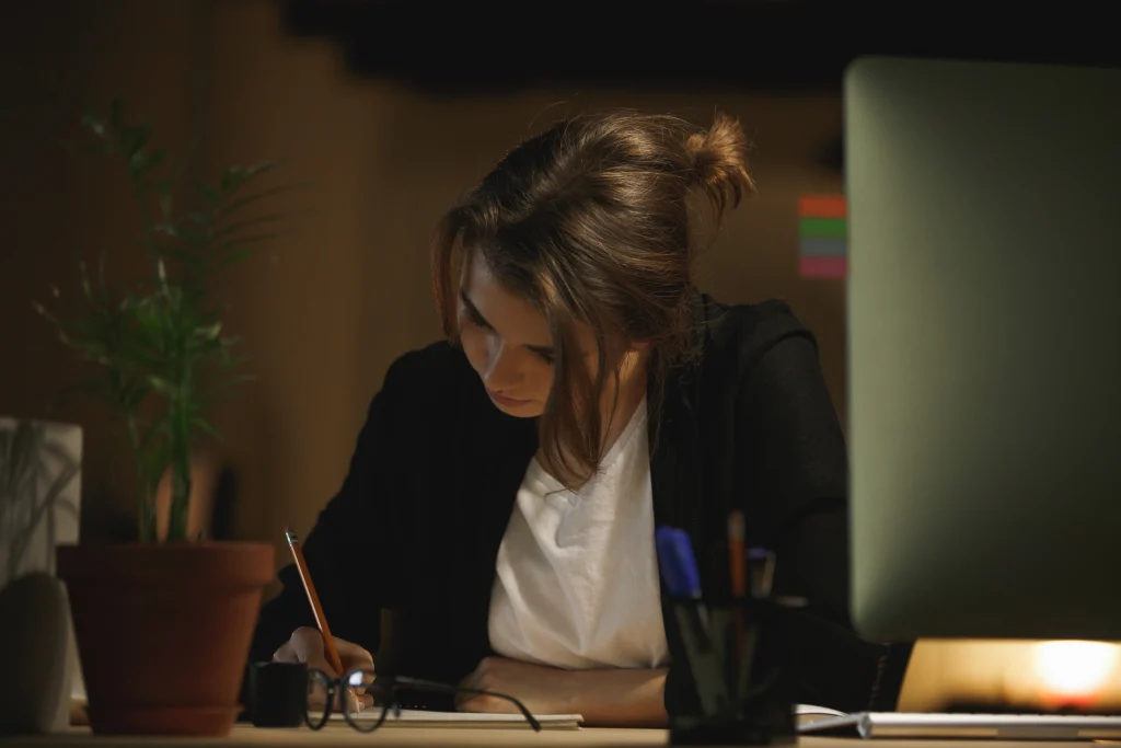 concentrated-young-lady-designer-sitting-office
