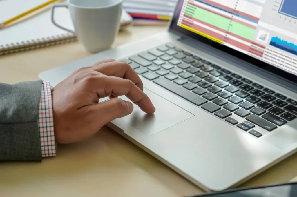 person typing on laptop keyboard